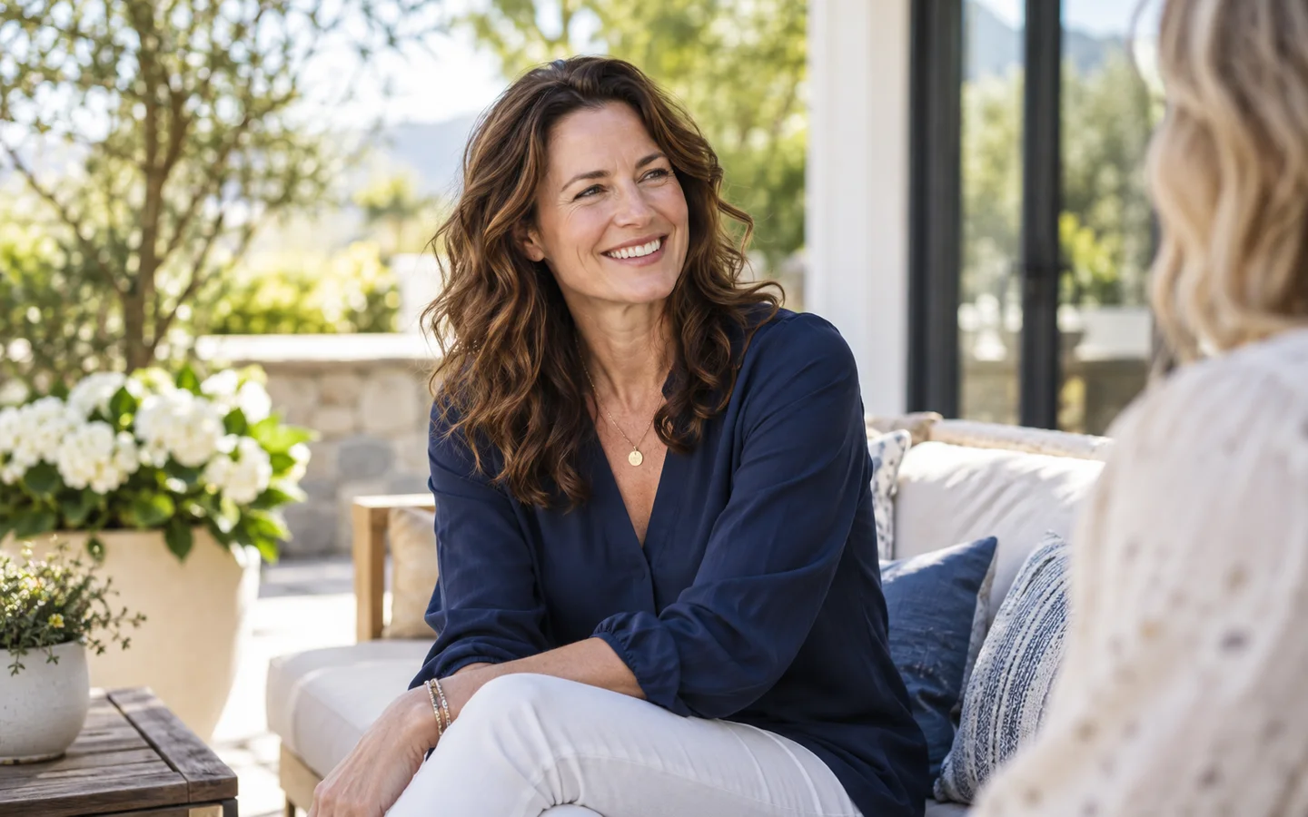 Woman smiling on a sunlit patio