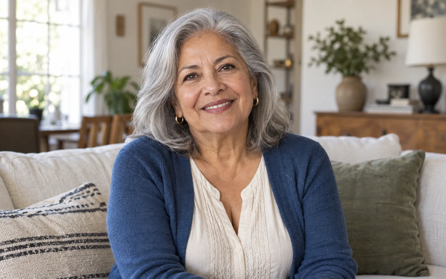 Silver-haired woman smiling at home