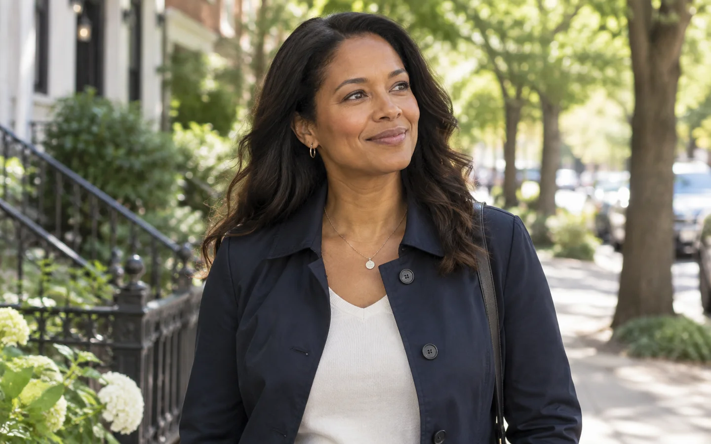 Woman smiling on a tree-lined street