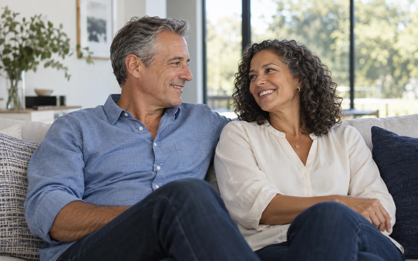 Middle-aged couple smiling together at home